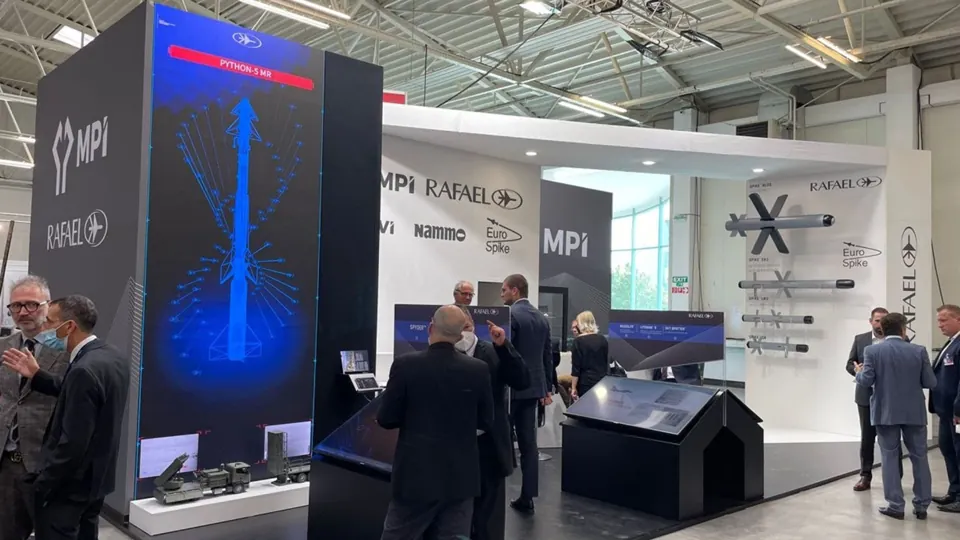 Air defense exhibition - Visitors beside a tall display and physical system models.